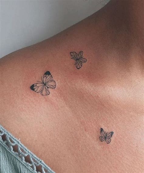 collar bone small butterfly tattoo on chest|49 eye